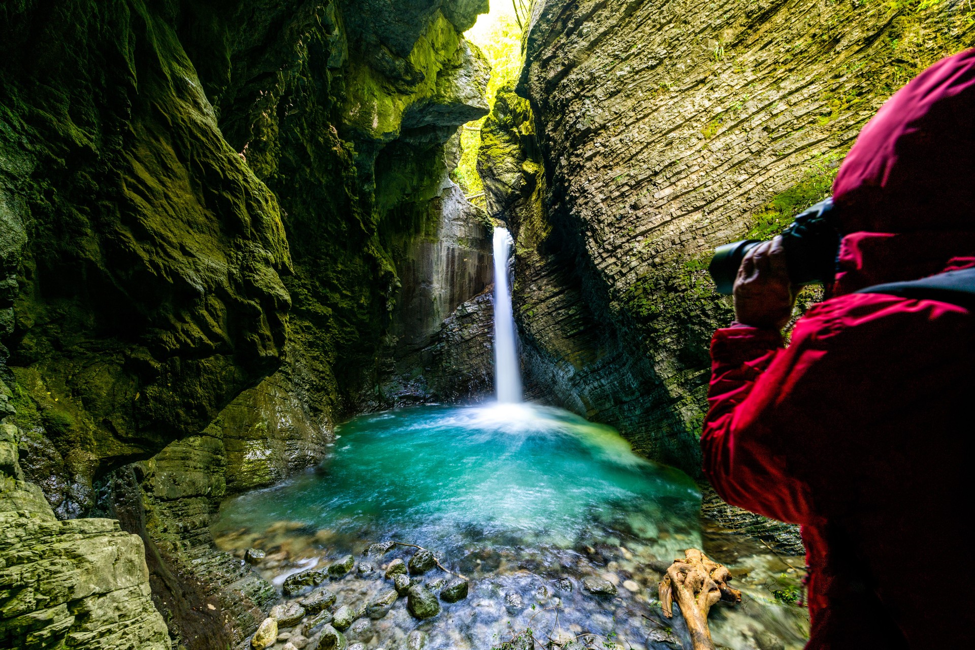 Photographer Exploring the Amazing Kozjak waterfall in Julian Alps canyon Slovenia